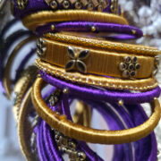 Festive purple & gold silk-thread bangles with kundan stones