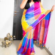 Woman wearing a pink Shatranj linen zari saree