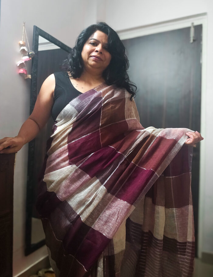 Brown linen saree featuring shimmering zari works