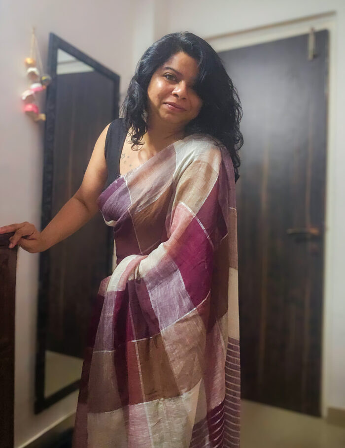 Brown linen saree detailed with delicate gold zari stripes