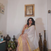 Mogra-toned linen saree finished with a gold zari border