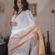 Elegant linen saree in mogra shade with metallic zari edge