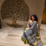 Light saleti linen saree draped on a model, with zari trim