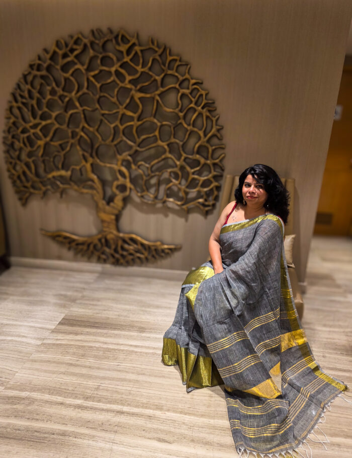 20250820_205718 Light saleti linen saree draped on a model, with zari trim