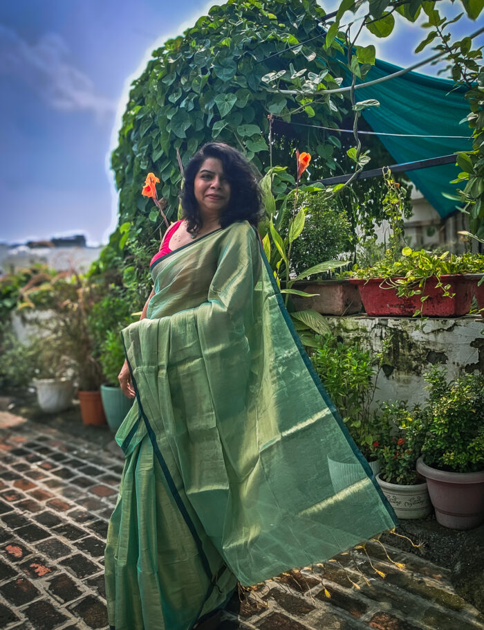 20250828_135642 Shimmer-finish green saree in garden setting