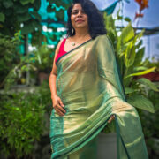 Green draped saree with soft reflective shine