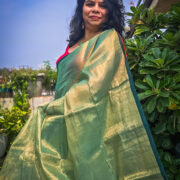 Green tissue saree showcased in natural light