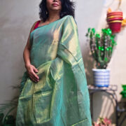 Lightweight green silk saree with glossy finish