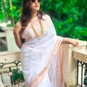 White handloom cotton saree featuring zari border