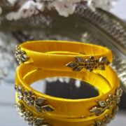 Yellow silk bangles with floral kundan motifs