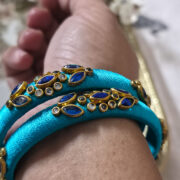Hand-wrapped kundan bangles in sky-blue silk thread