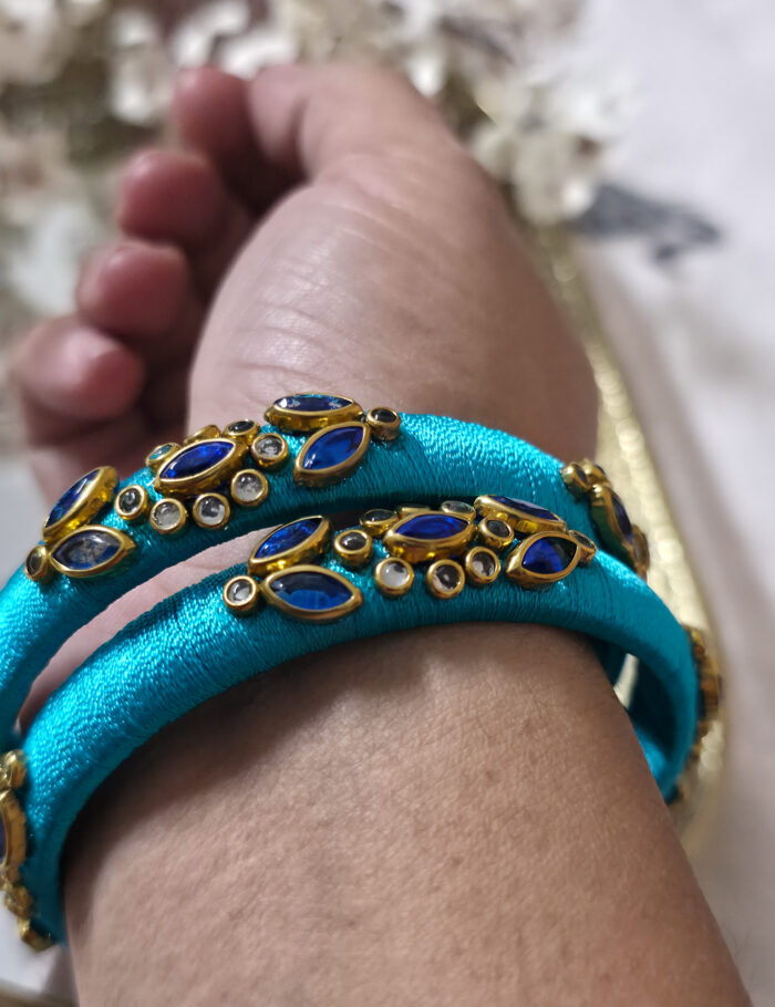 Hand-wrapped kundan bangles in sky-blue silk thread
