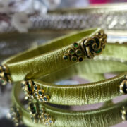Two pista-green silk-wrapped kundan bangles