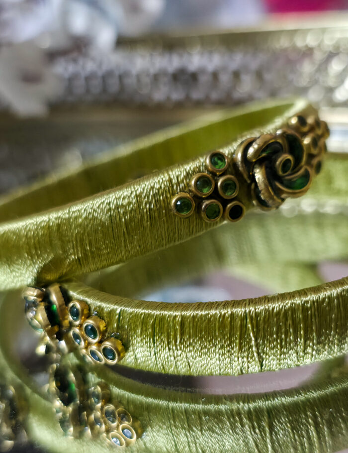 20250923_210721 Two pista-green silk-wrapped kundan bangles
