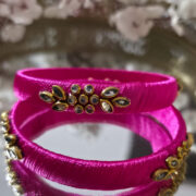 Pink silk-thread bangles with golden kundan stone detailing