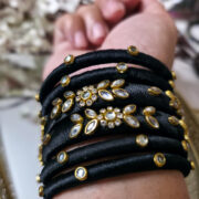 Handcrafted kundan bangles wrapped in black silk thread