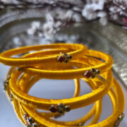 Two matching silk-thread bangles studded with kundan
