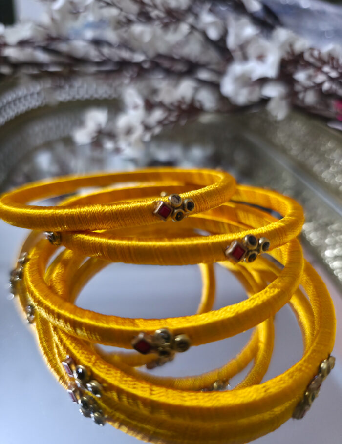 20250927_225229 Two matching silk-thread bangles studded with kundan