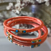 Two handcrafted silk-thread bangles with kundan stones