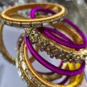 Silk thread kundan bangle set in gold and fuchsia