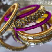 Ethnic gold kundan bangles with magenta silk detailing