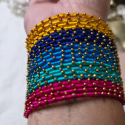 Four colorful silk-wrapped metal bangles