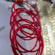 Four festive silk-thread bangles with metallic base