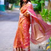 A classic Banarasi silk saree featuring a metallic zari border.