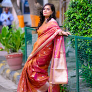 Luxurious Banarasi silk saree highlighting a gold zari border.