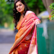 Elegant Banarasi silk saree featuring a wide zari border.